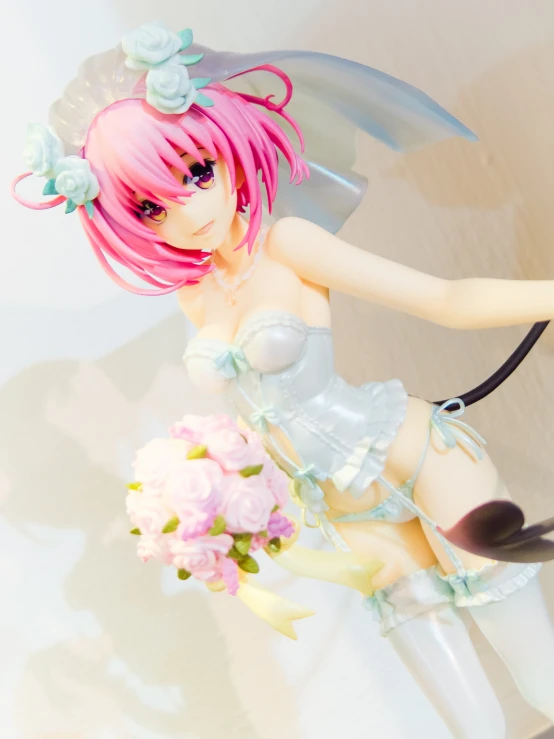 a doll is holding a umbrella and flower bouquet