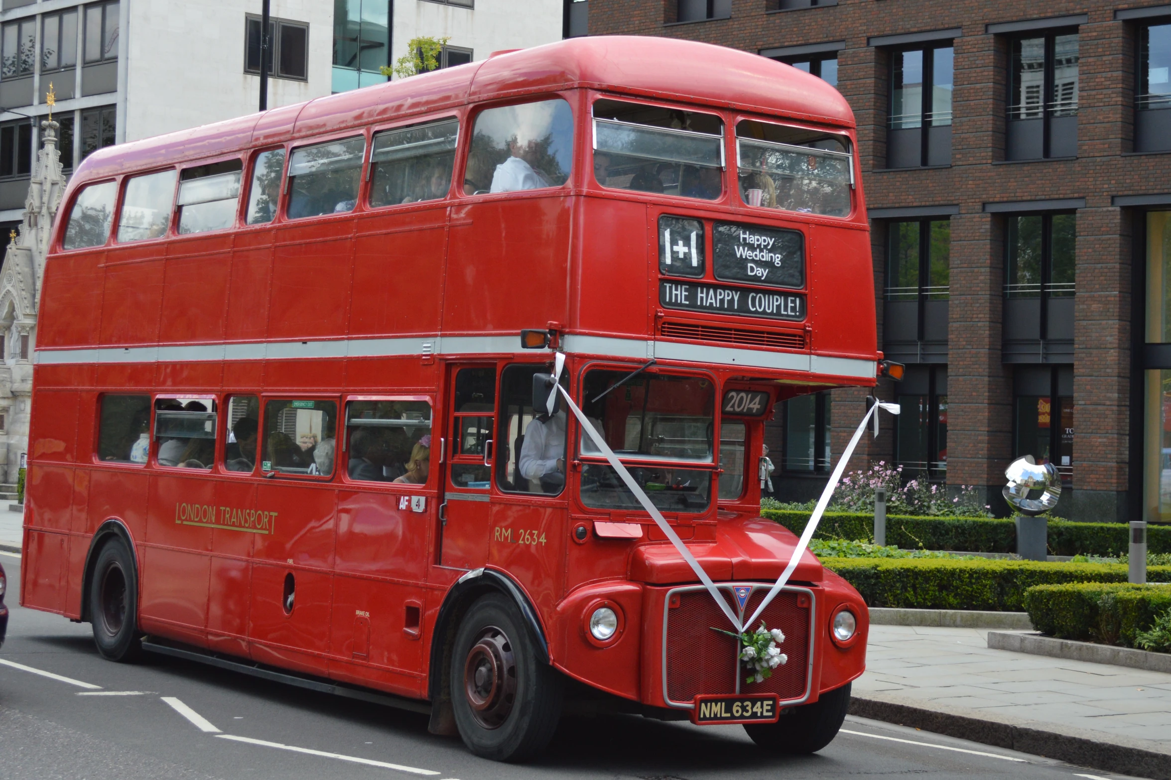 a red double decker bus driving down the road