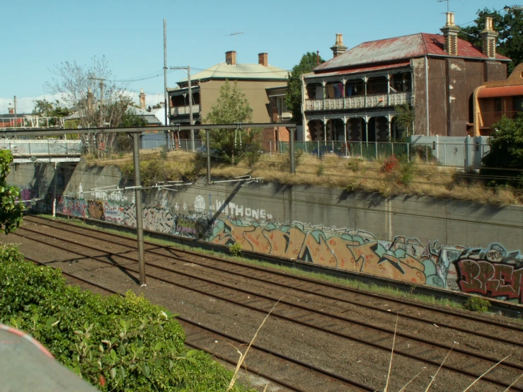 an empty rail road track with train passing by