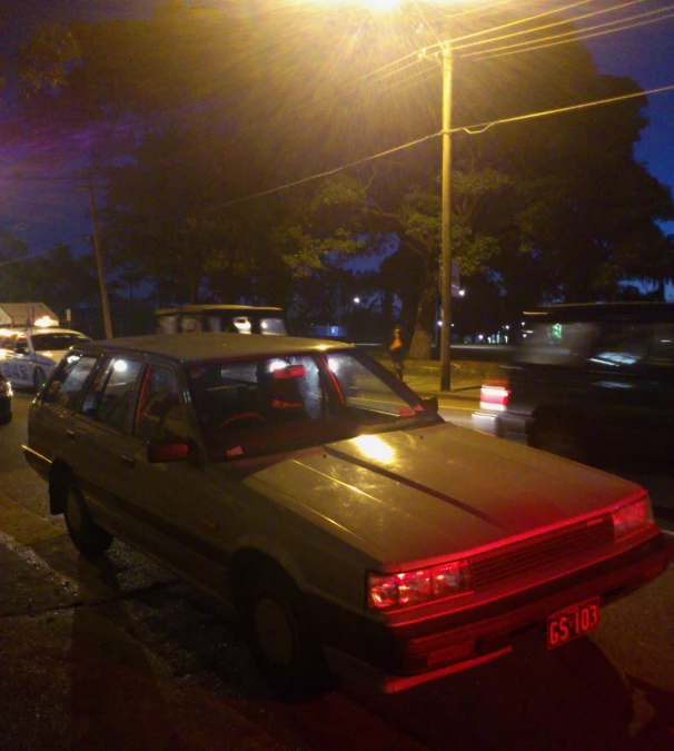 a car that is parked at a light in the dark