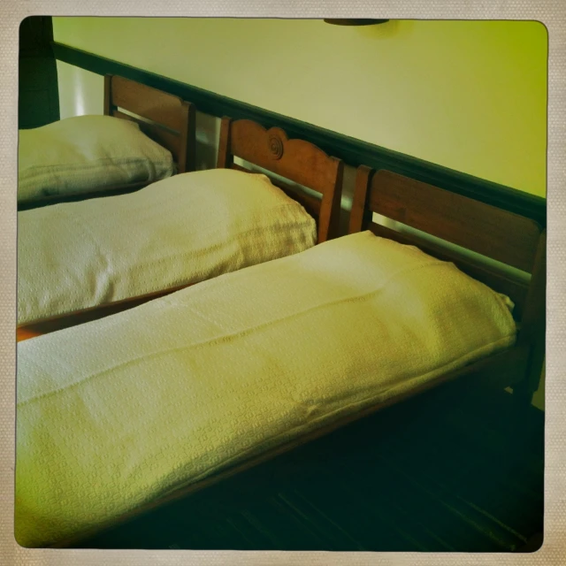 an image of two beds that are made up
