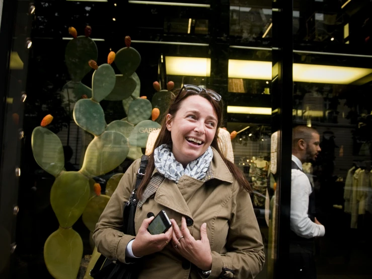 a woman standing in front of a glass door