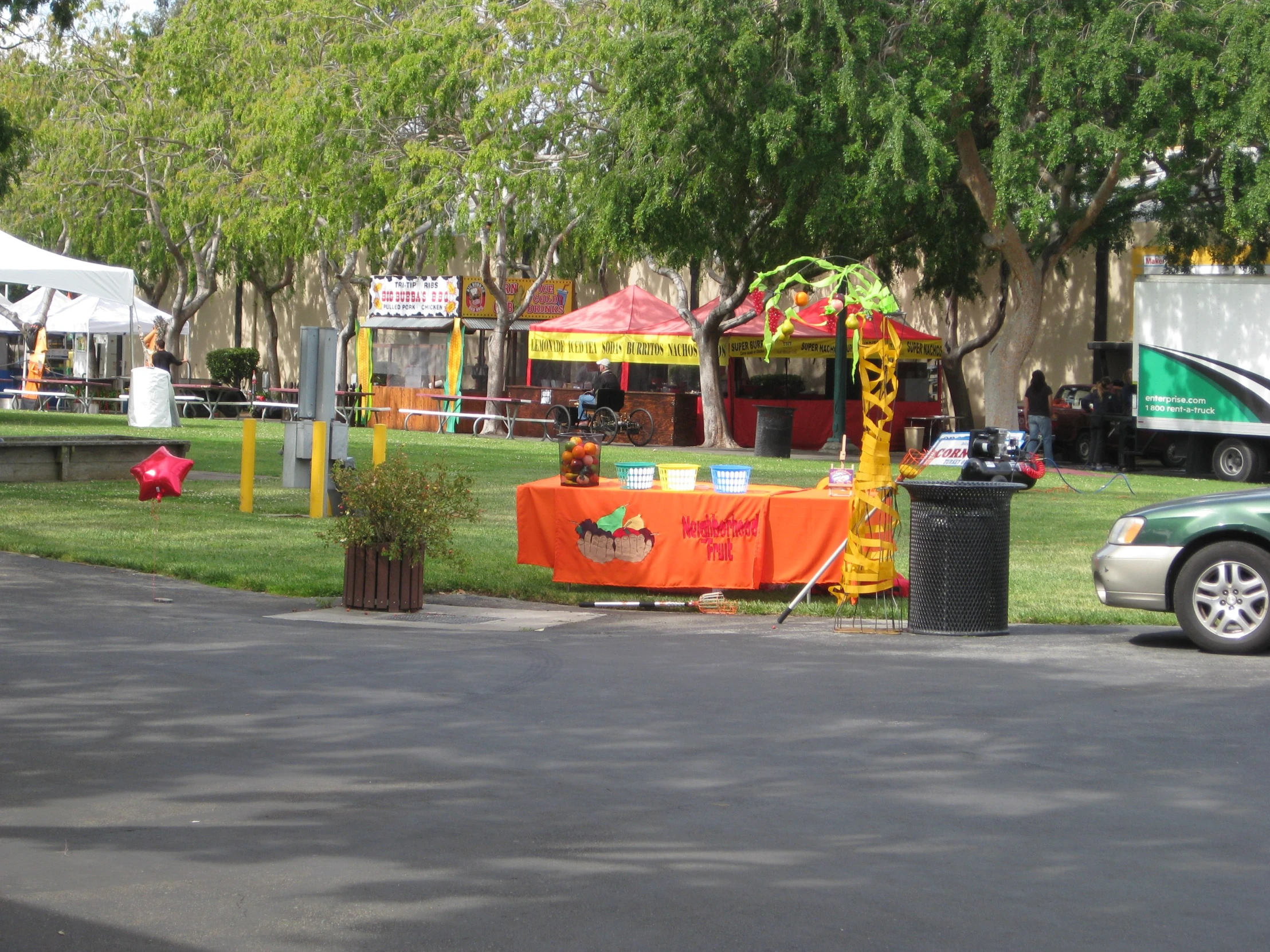 two children's carnival rides in the background with cars on it