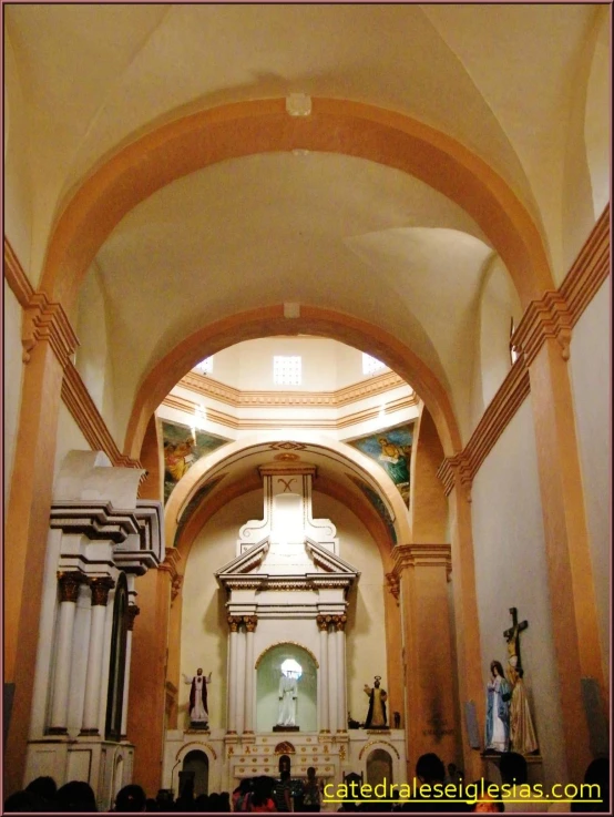 the inside of a church with people gathered around