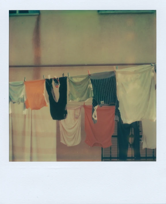an old po showing a row of clothes hanging from a rack