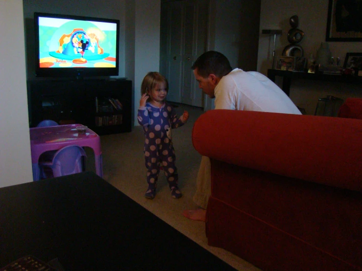 the man and little girl are playing in the living room