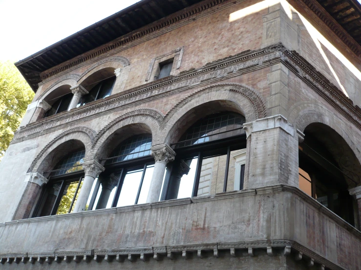 a brick building has windows with some columns and arches