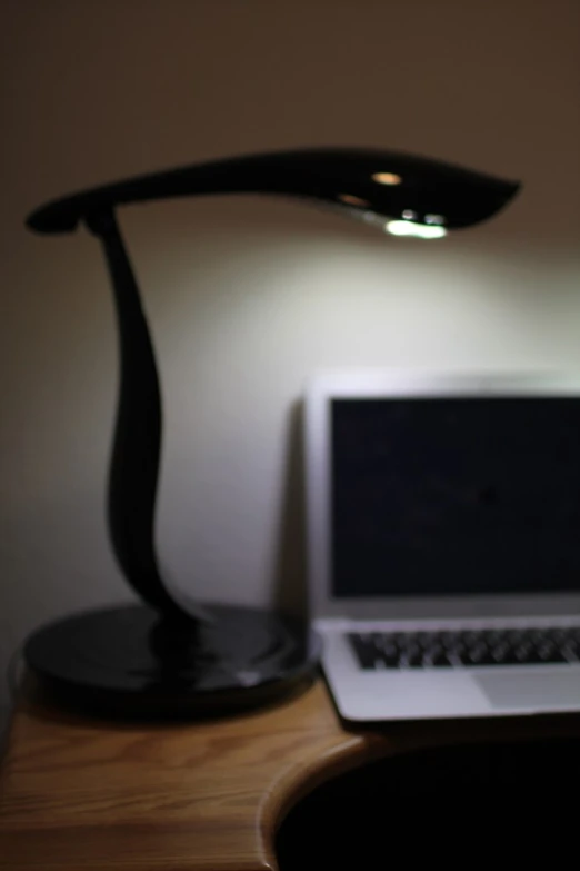 a small white laptop sitting on top of a desk