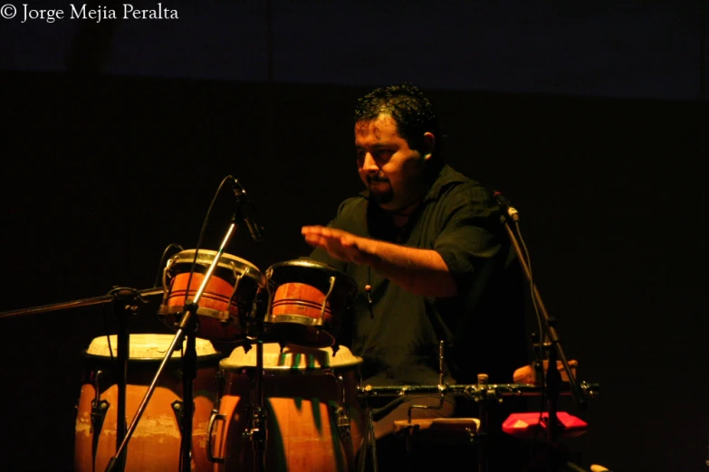 a man is playing music in front of a microphone