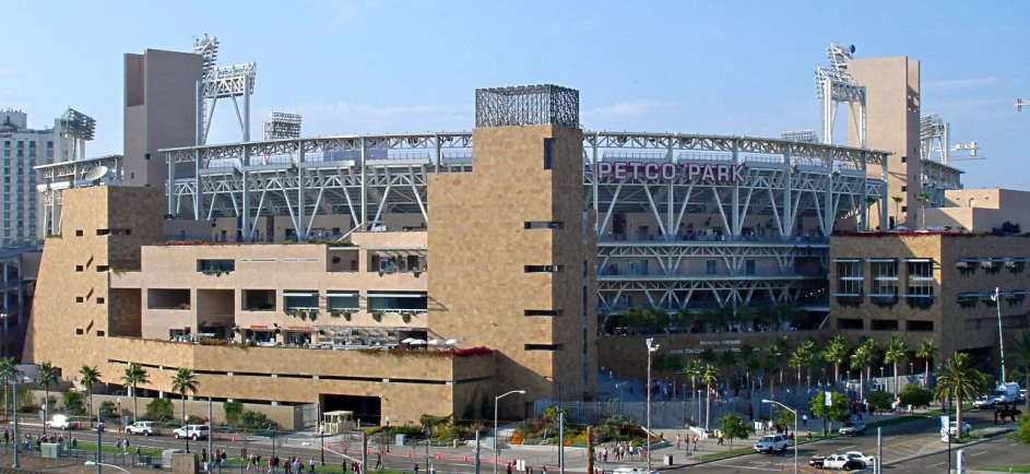 large stadium building near the city in the daytime