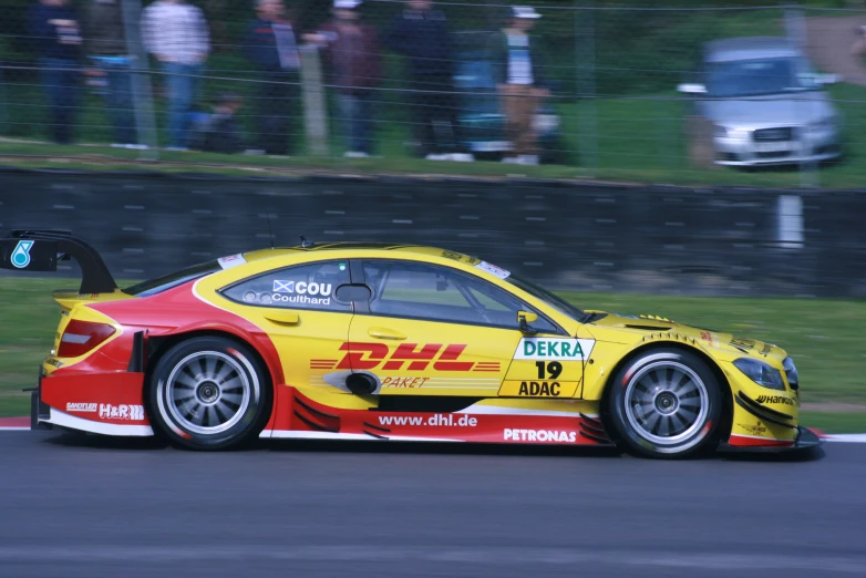 a car races around the track with other spectators