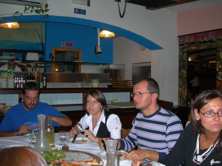 four people seated at a table in a restaurant