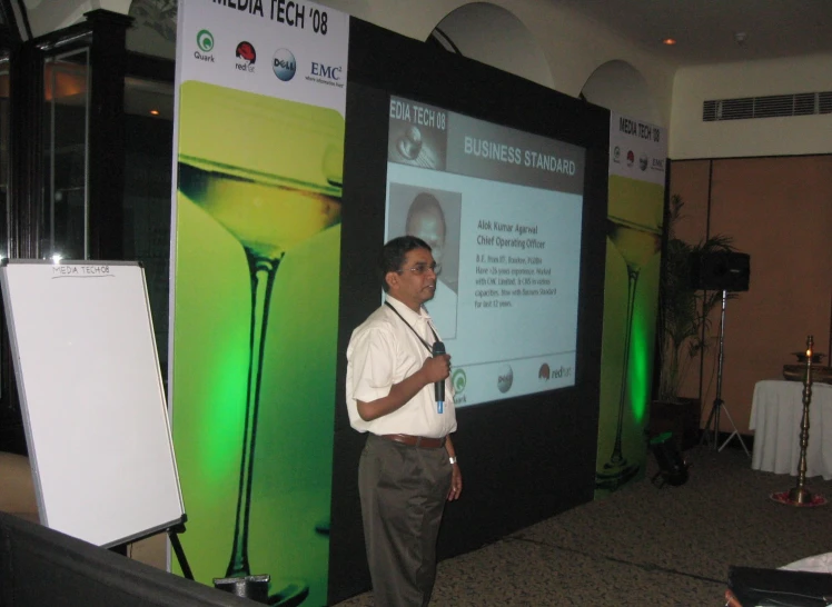 man standing in front of screen giving presentation