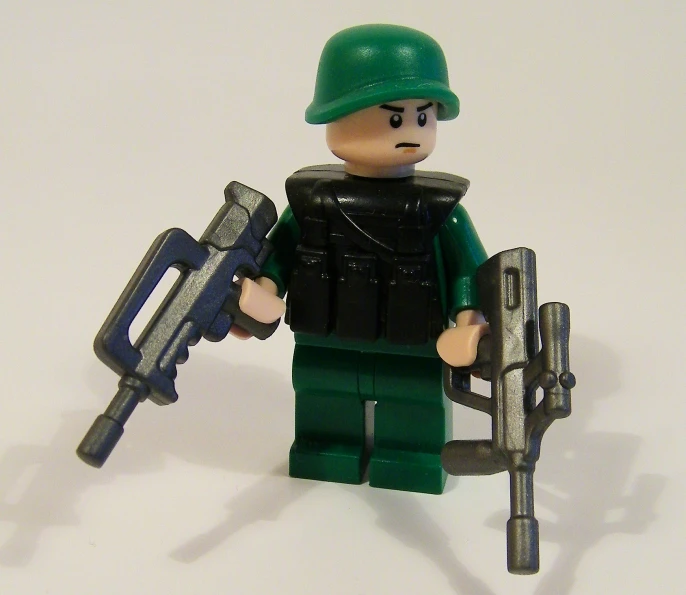 lego man with machine gun on white background