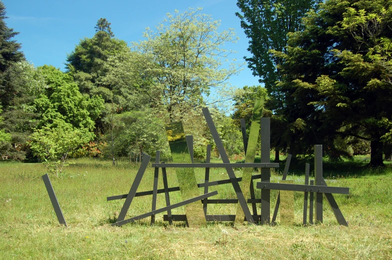 a pile of sculptures sitting in the grass