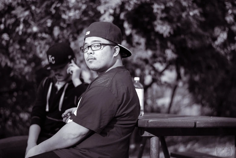 two people sitting on benches looking at soing