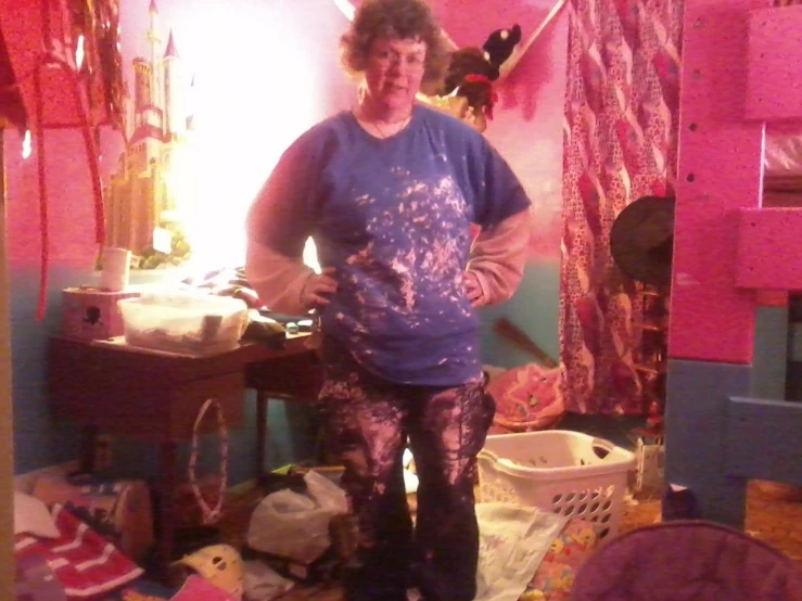 a woman in patterned pants standing next to a bedroom