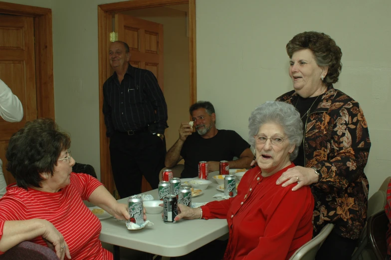 a group of people sitting at a table in a living room