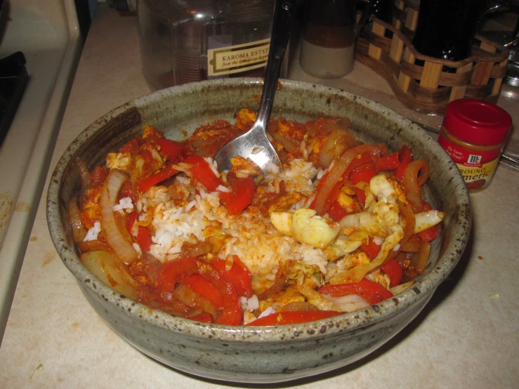 a large bowl of food with spoon in it