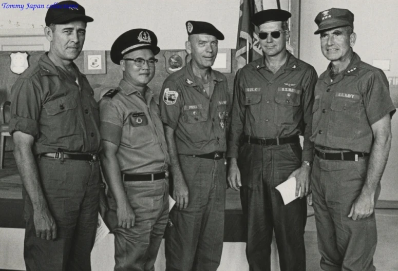a group of men in uniform posing together