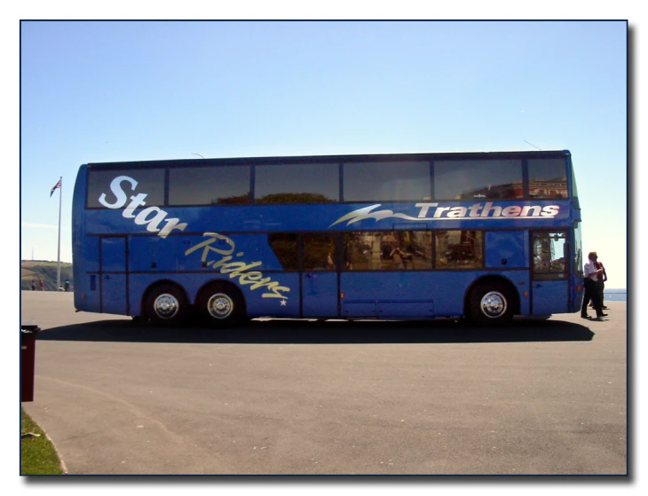 blue bus with graffiti advertising at airport near passengers