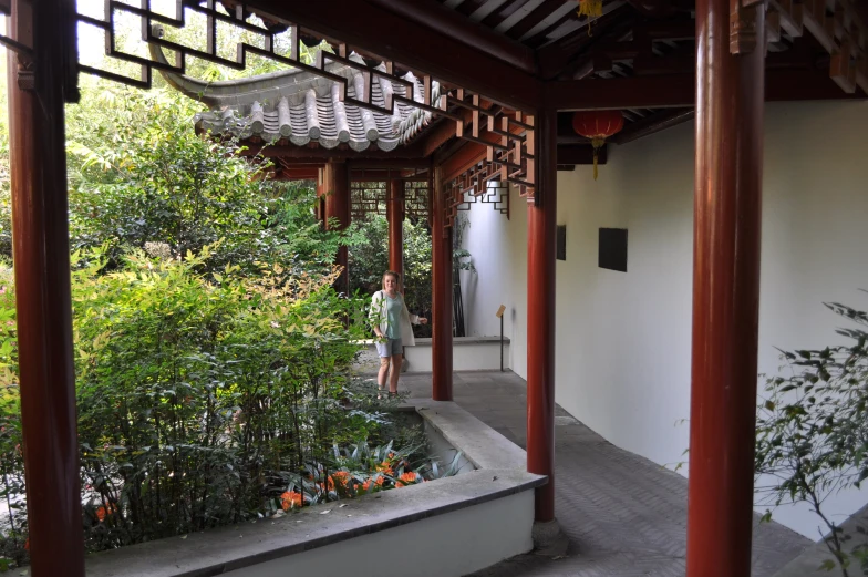 a woman is looking over a large garden