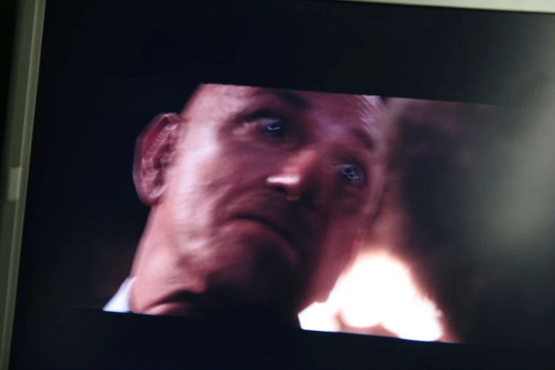 a man is staring through the opening in a television