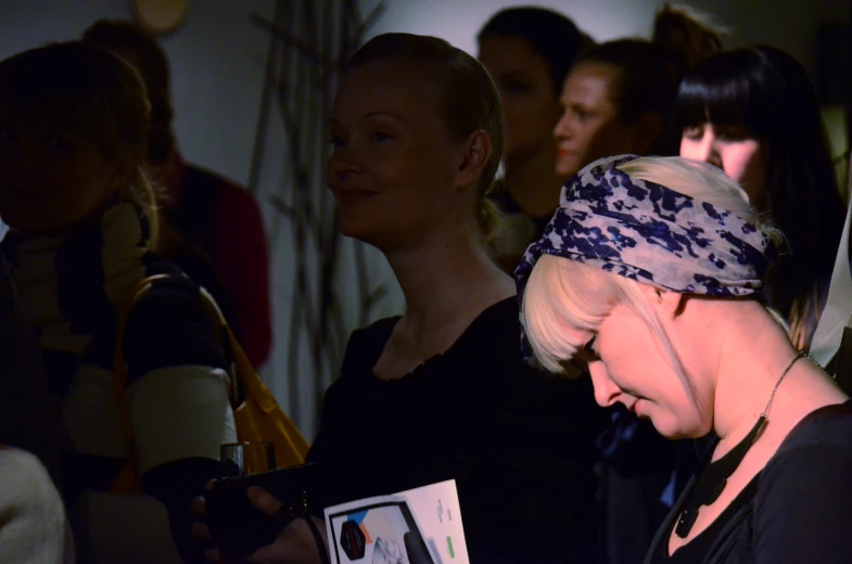 a woman in black shirt standing next to some other women