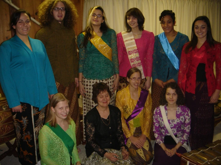 people in different colored costumes posing for a po