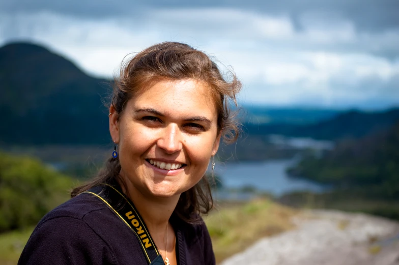 a young woman is taking a po of herself on top of the mountain