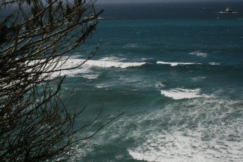 some water waves coming in to shore by a ship