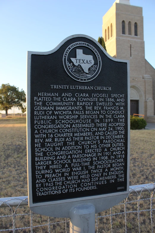 a sign is shown in front of a gate that has words on it