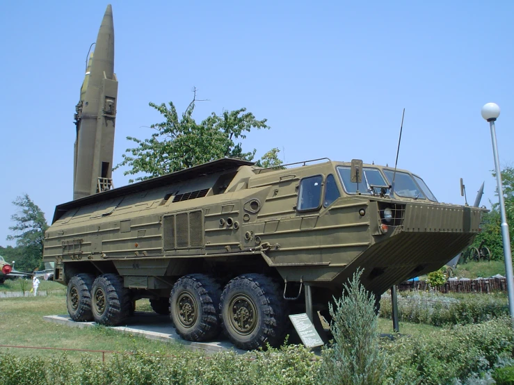 a very large army vehicle with big tires