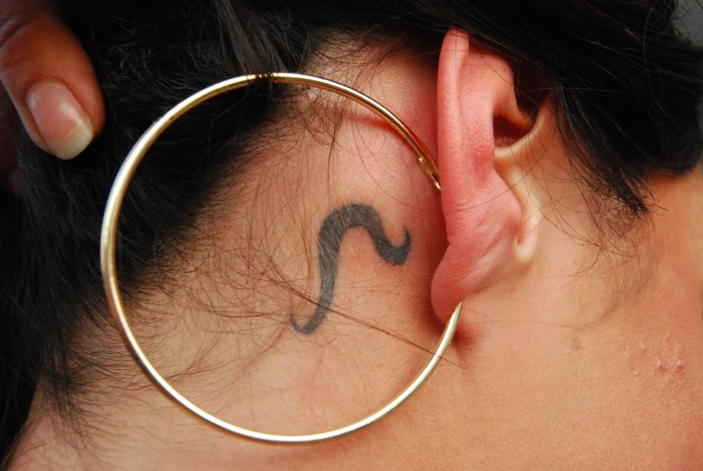 a person has a large hoop around the ear