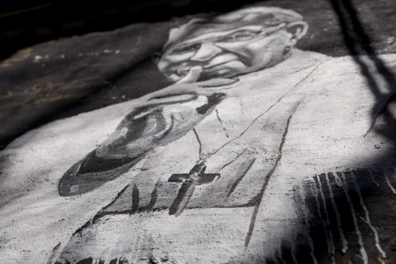 graffiti depicting president lincoln with a cross on the wall