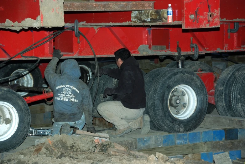 a man working on some big tires inside a truck