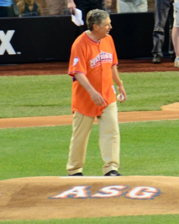 a man standing on a baseball field holding a bat