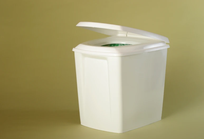 a white container with a lid sitting on a yellow background