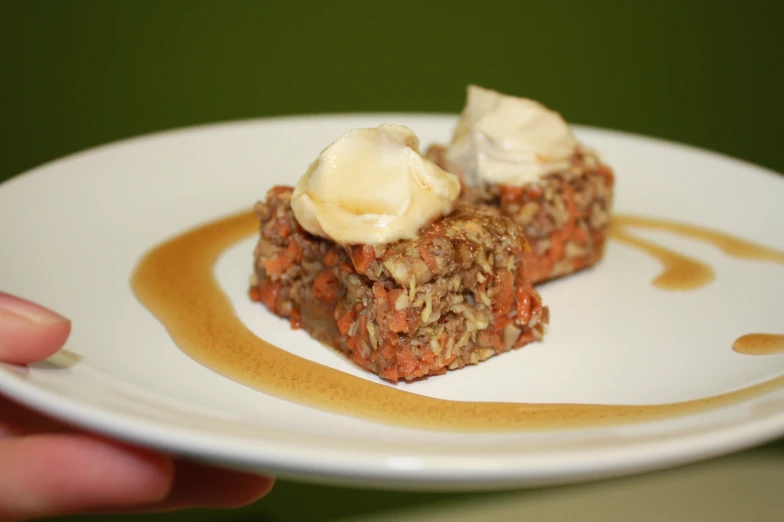 a plate with a few bites of cake covered in cream