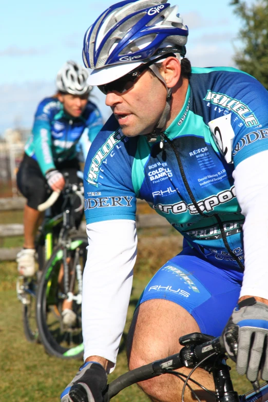 the men are riding their bikes through the field