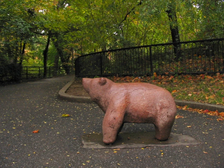 a statue is shown on the ground next to trees