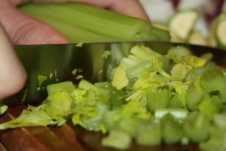 a person chopping vegetables on top of a  board