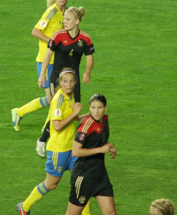 some s playing soccer on the field