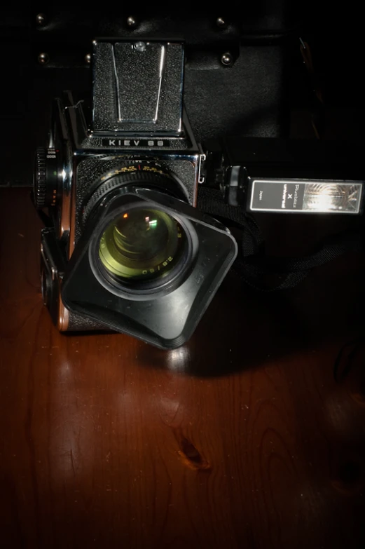 a camera on a table is shown with a lit lens