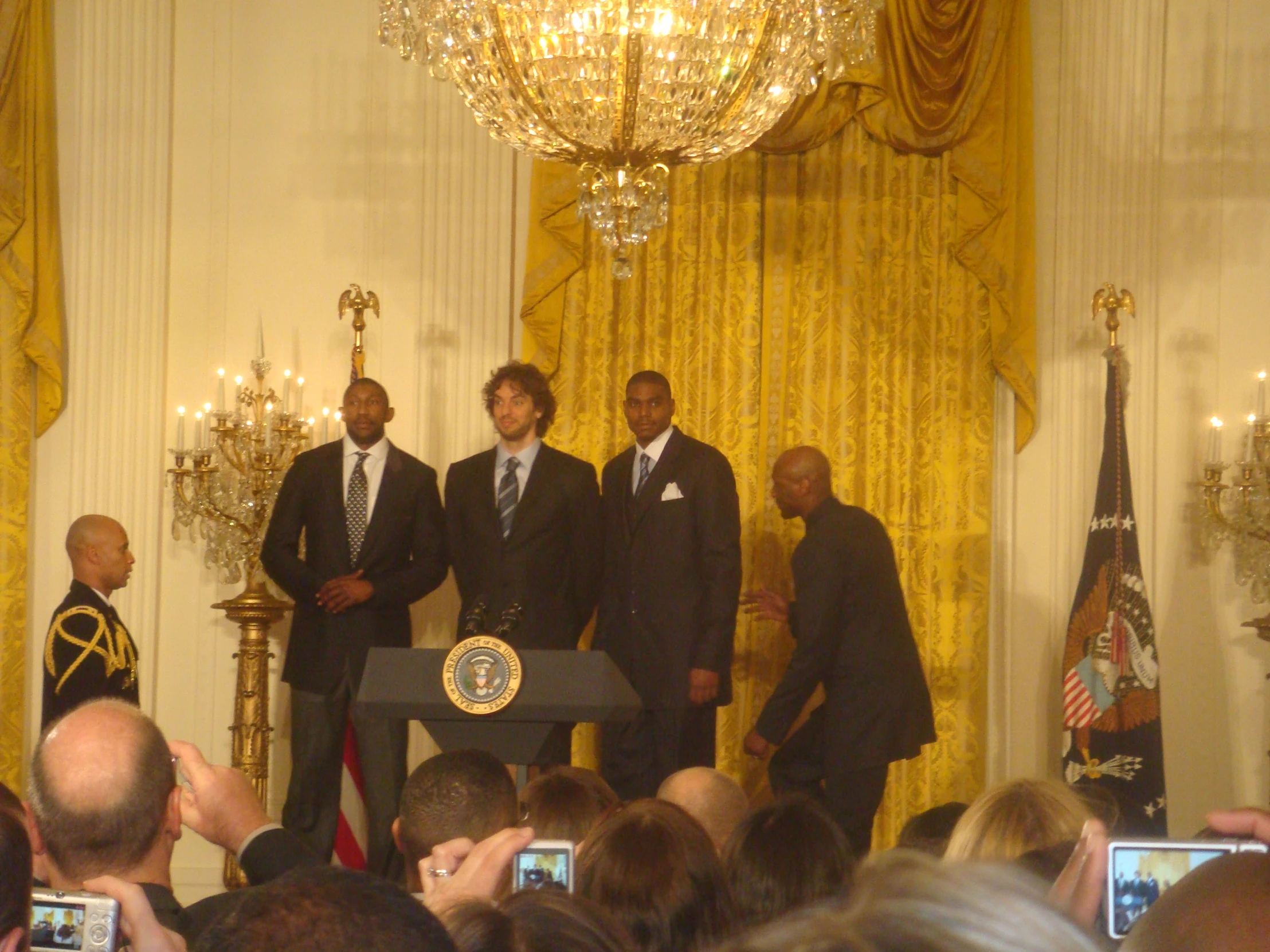 people are standing in front of two men in business suits in the white house