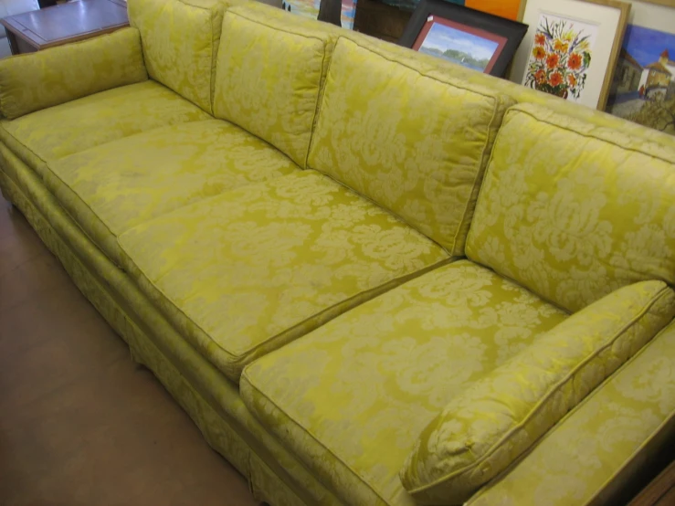 a living room couch set up on a shop floor