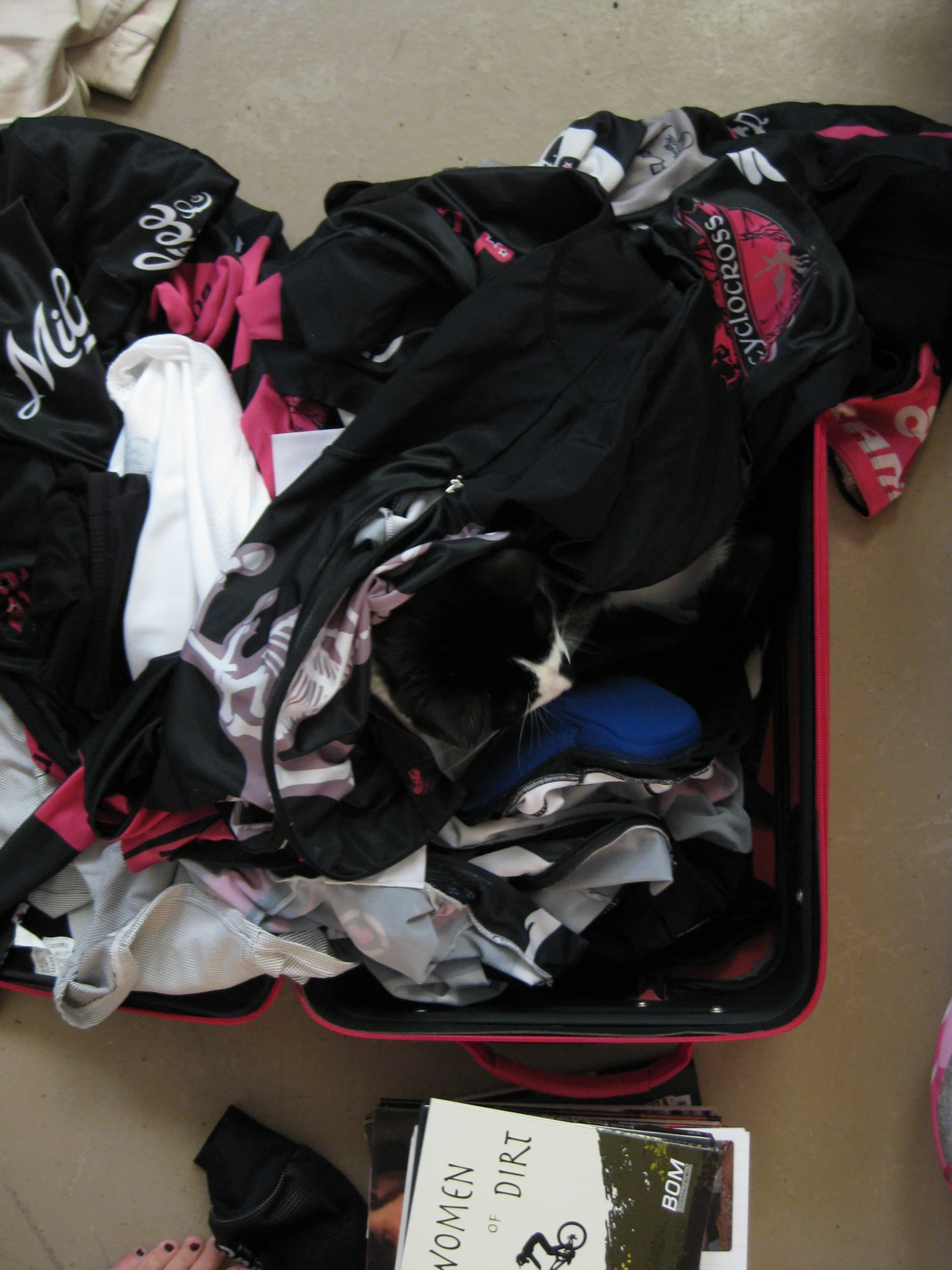 there is a suitcase filled with clothing and shoes