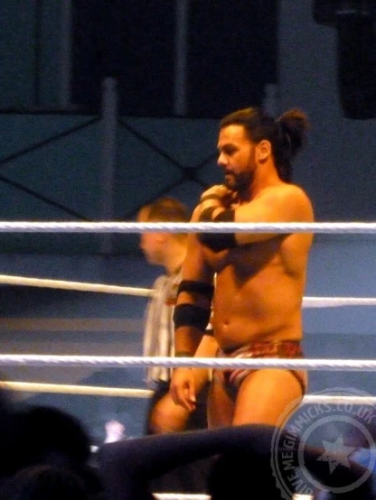 a man with a woman standing by him in a wrestling ring