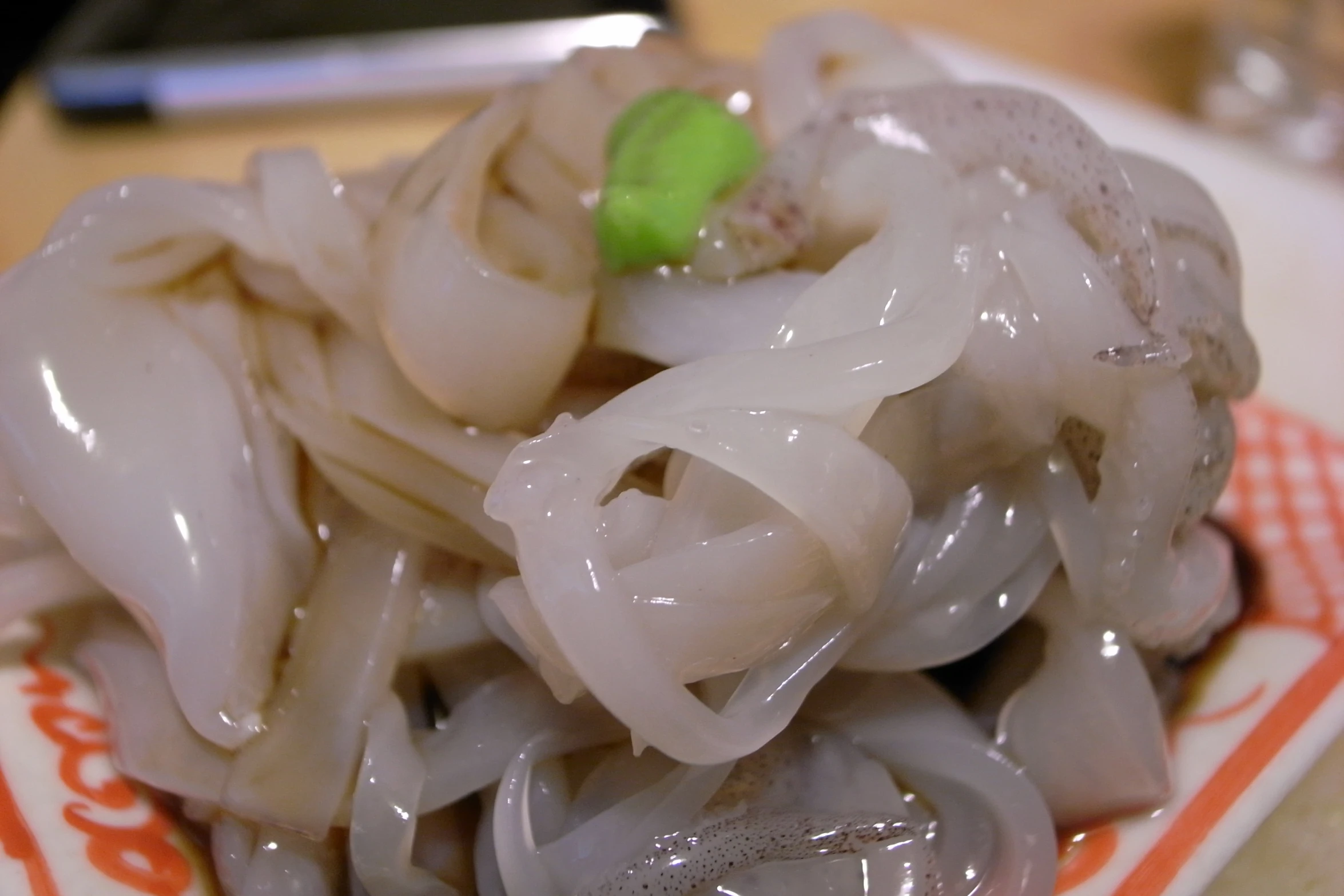 a plate full of steamed onion with a green object on top