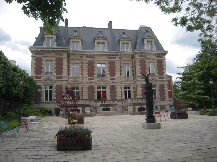 a large house sitting on top of a cement block